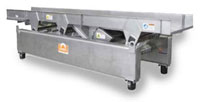 Eriez vibratory conveyor shown as a mechanical conveyor mounted on base.